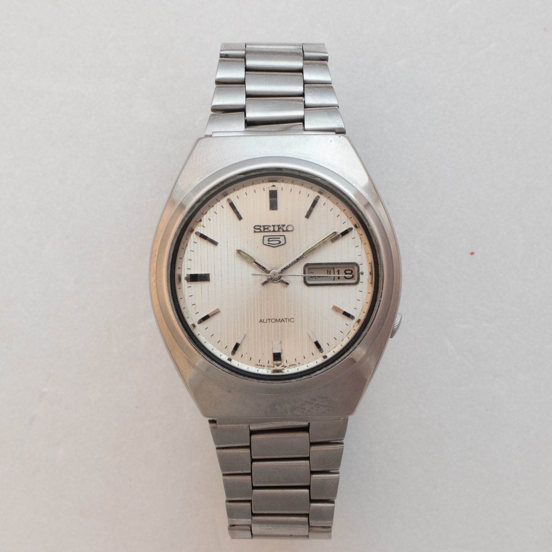Front view of Vintage Seiko 5 7009-8760 Automatic Silver Pinstripe Dial Watch
