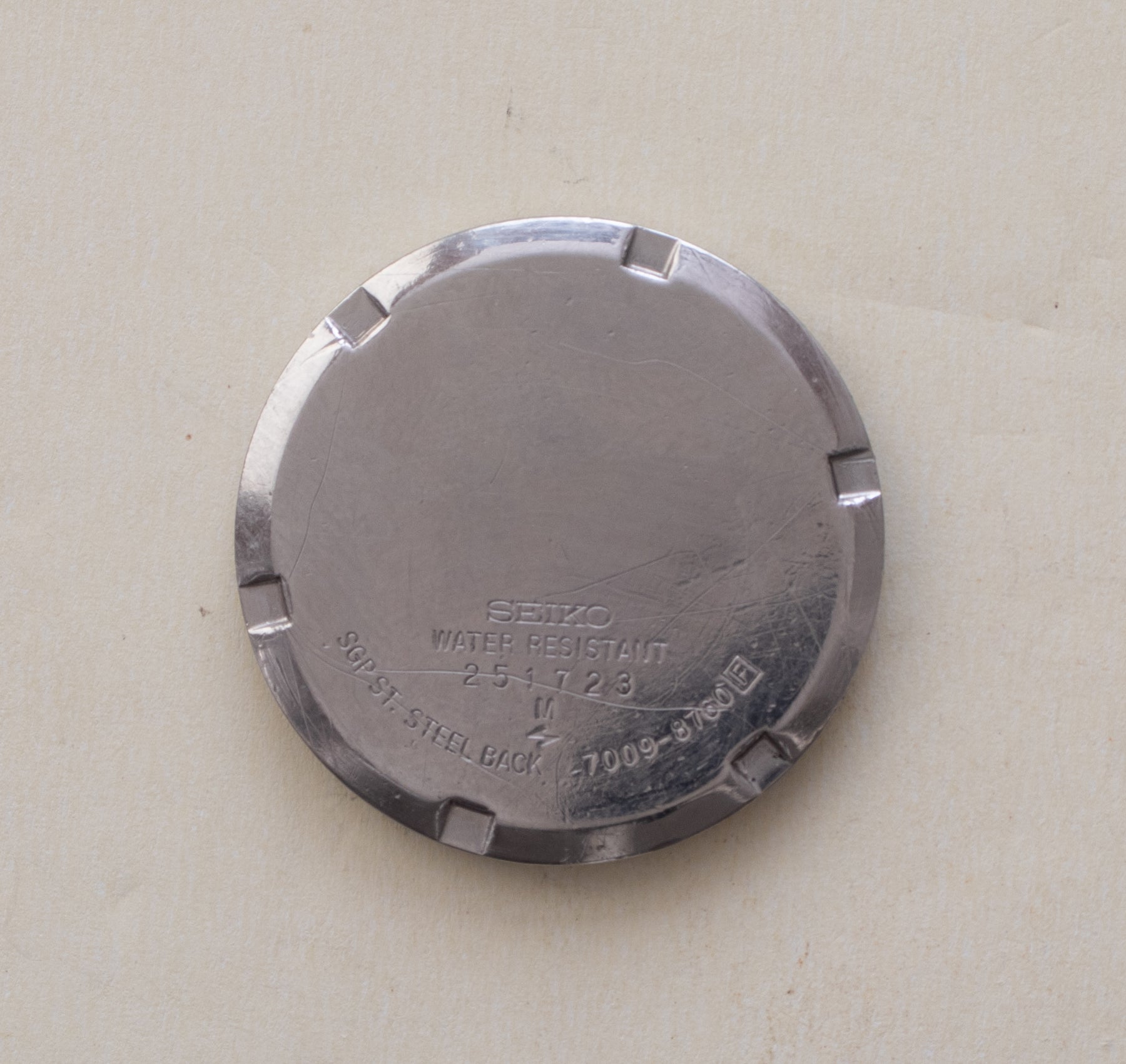 Caseback of Vintage Seiko 5 7009-8760 Automatic Silver Pinstripe Dial Watch showing reference details
