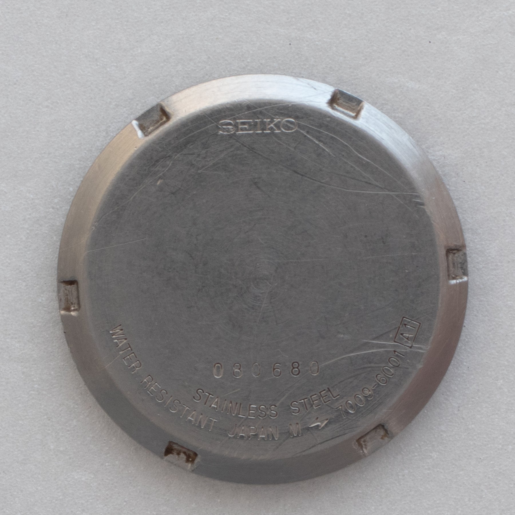 Caseback of Vintage Seiko 5 7009-6001 Automatic White 24-Hour Dial Watch showing reference details