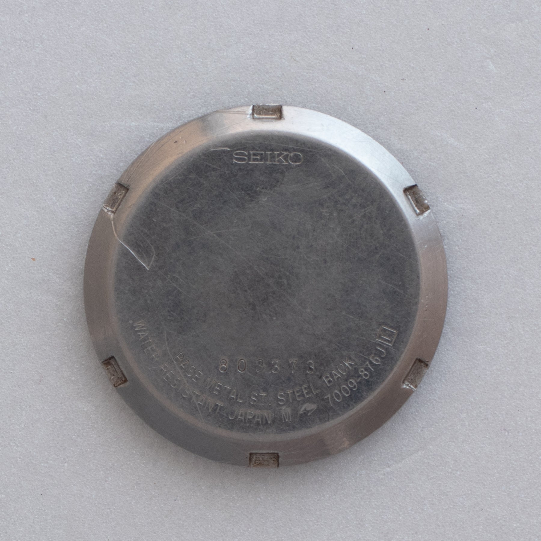 Caseback of Vintage Seiko 5 7009-876J Automatic White Checkerboard Dial Watch showing reference details